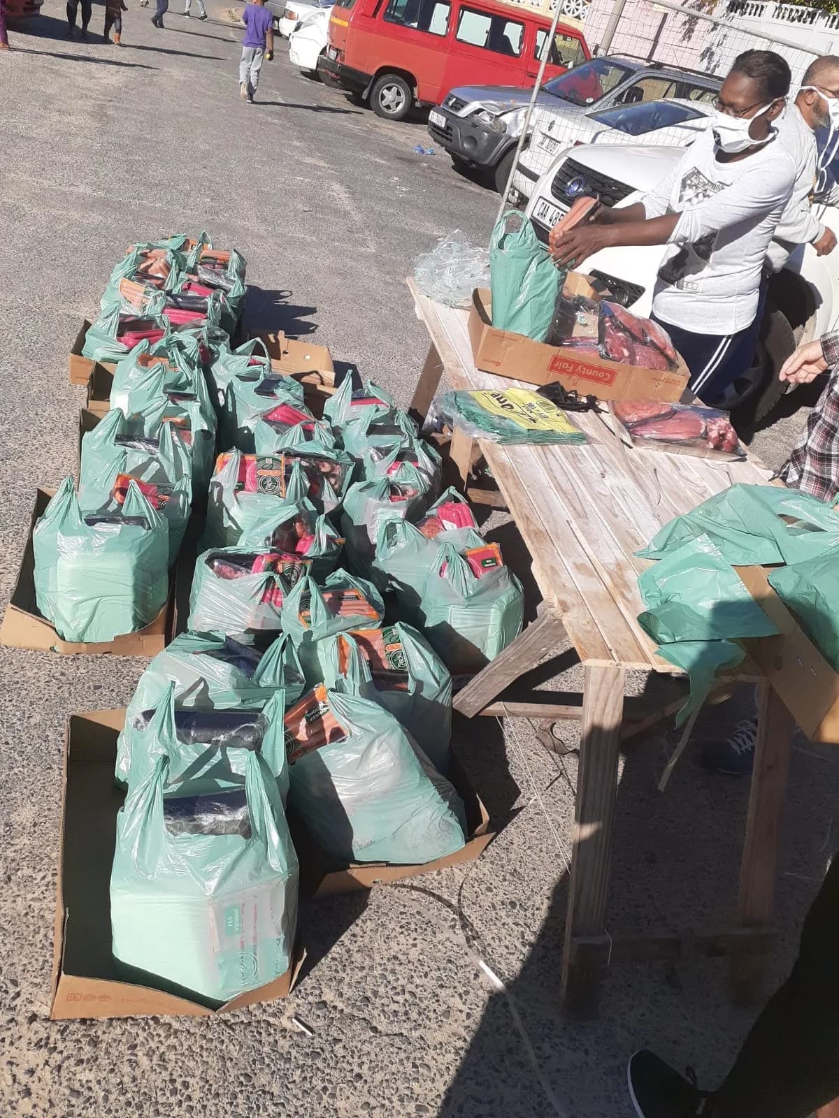 Bayside team members handing over donations during a community outreach drive