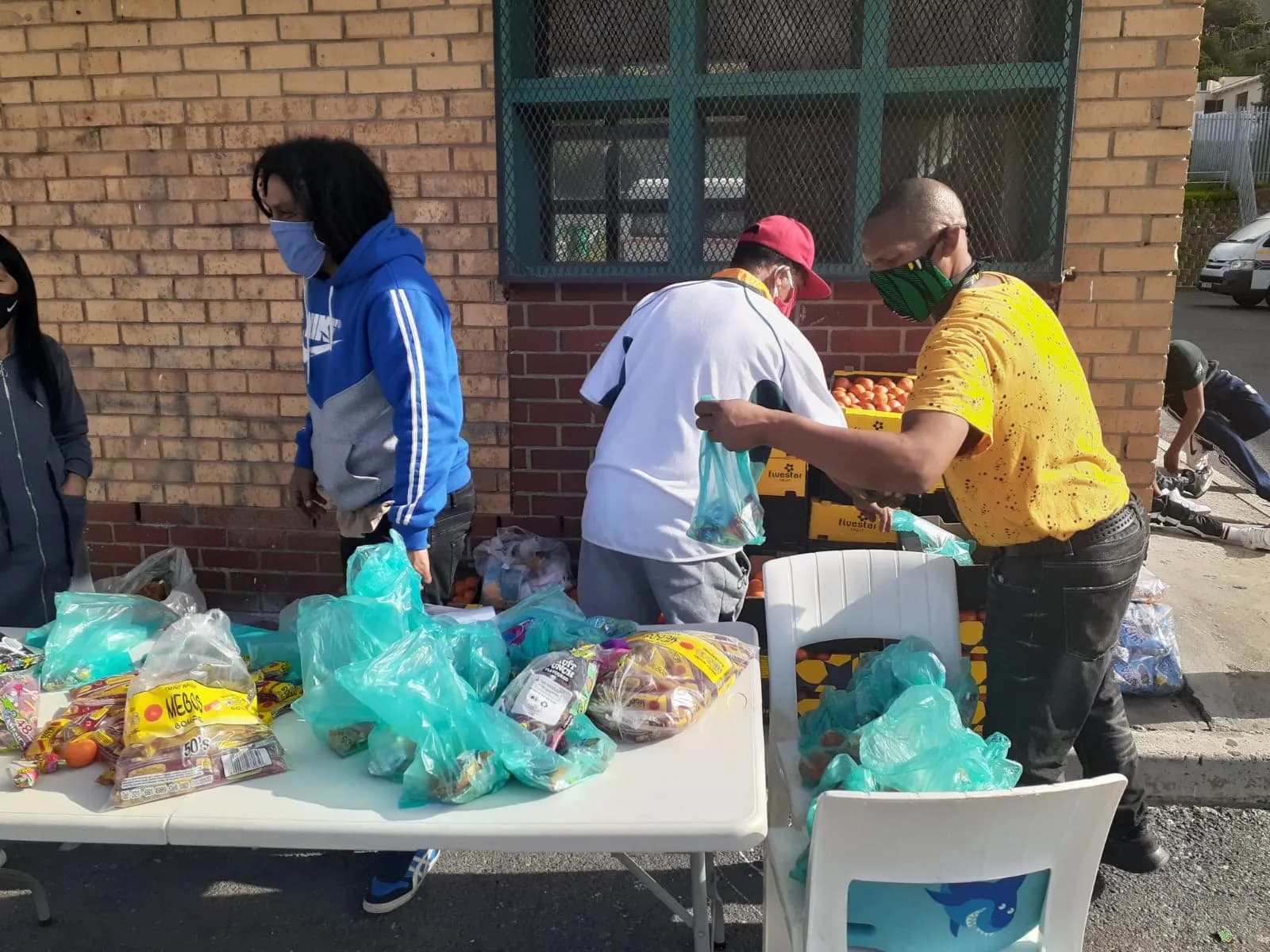 Volunteers distributing food and essential supplies to local families
