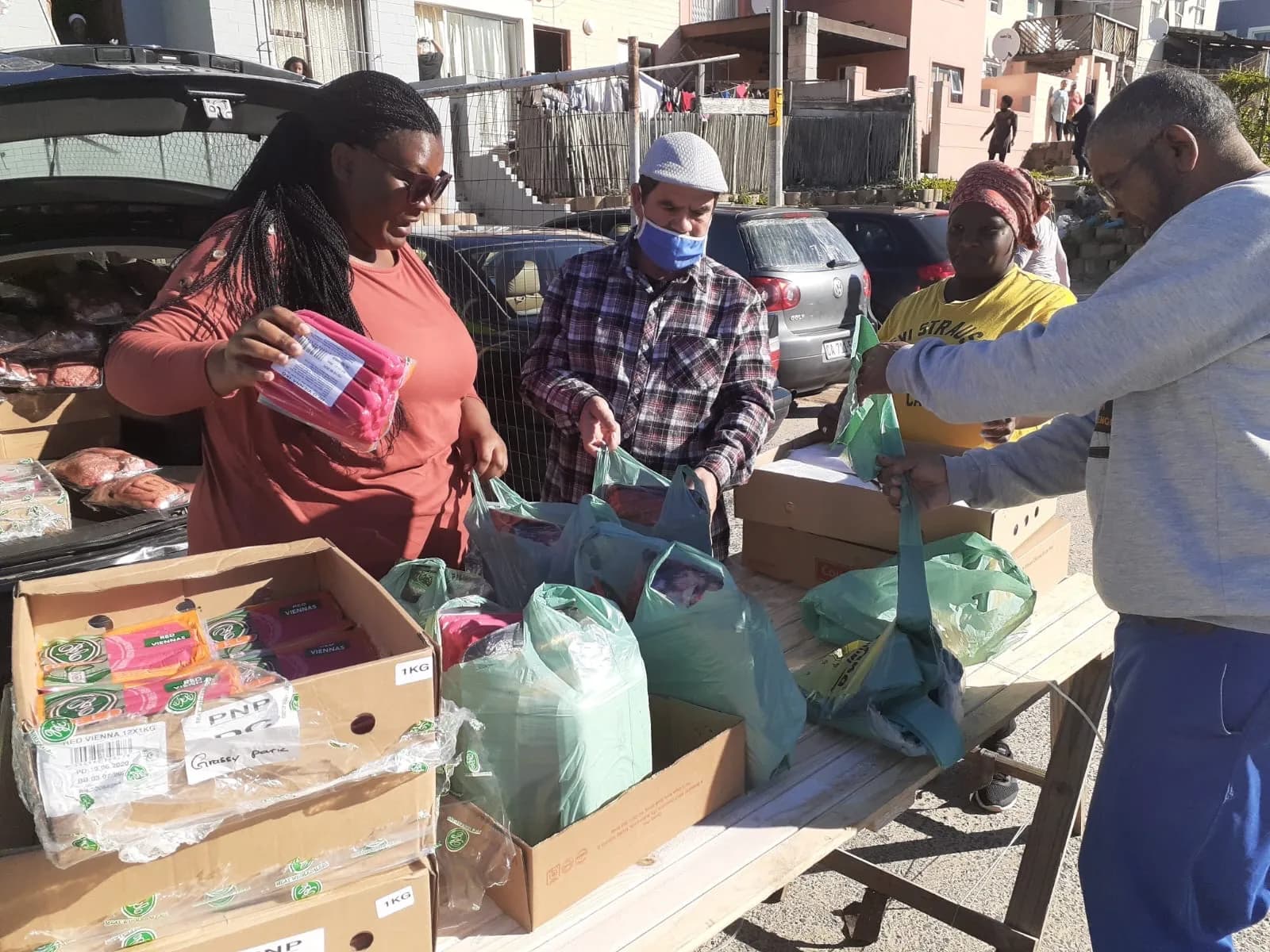 The Bayside team with community members at an outreach event