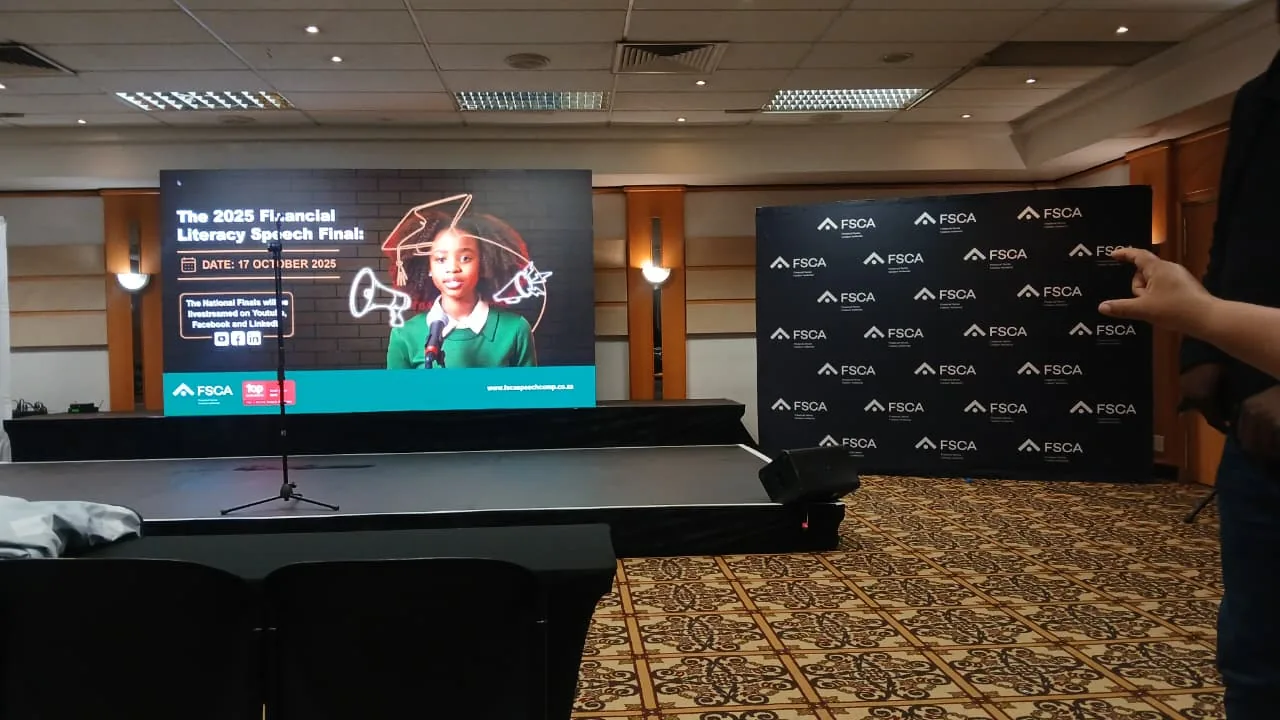 A finalist delivering a speech at the podium during the Financial Literacy Speech Competition finals
