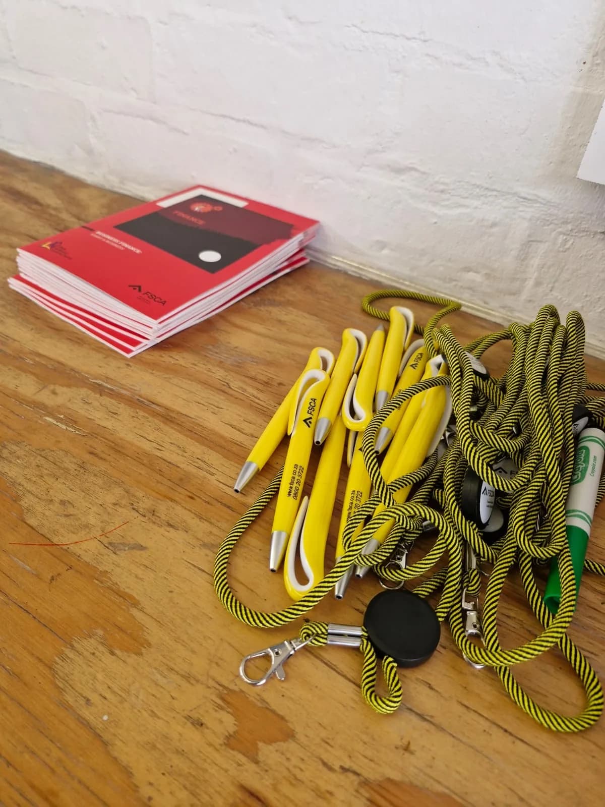 FSCA branded pens, lanyards and financial literacy booklets prepared for delegates