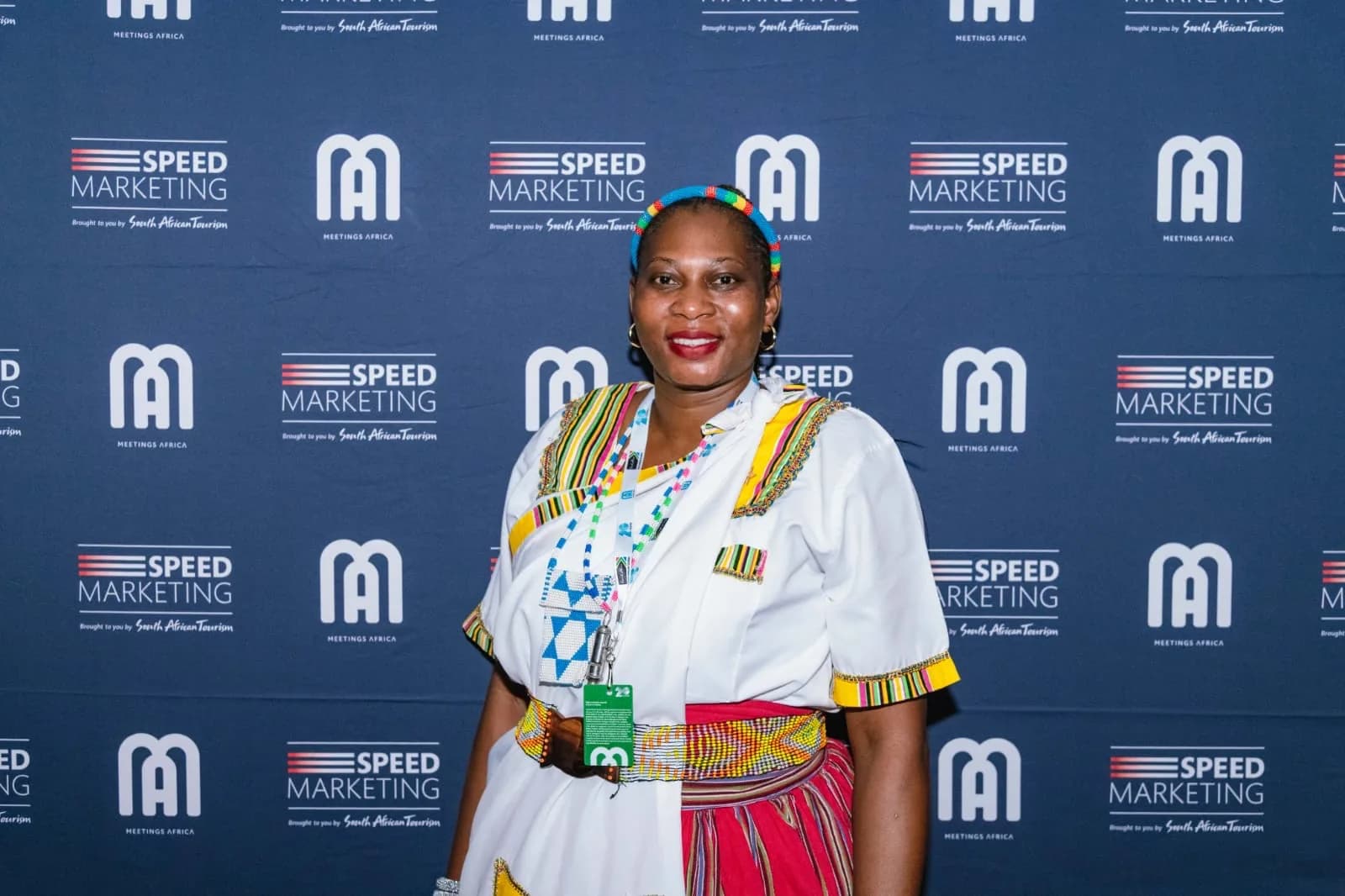 Delegate in traditional dress at the Meetings Africa 2026 photo wall
