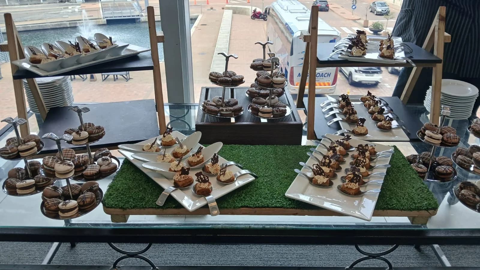 Catering display of desserts and canapes set up overlooking the CTICC forecourt