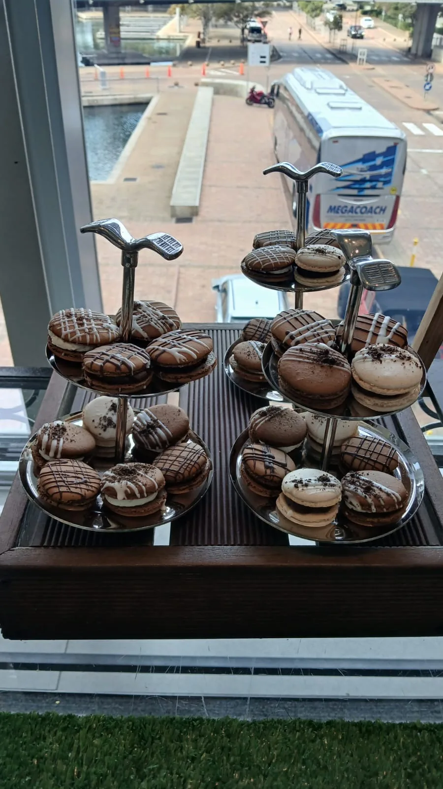Tiered stands of chocolate macarons at the National Language Summit refreshments station